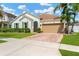 Inviting single-Gathering home with a well-kept lawn and garden, enhanced by swaying palm trees at 11423 Brighton Knoll Loop, Riverview, FL 33579