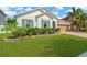 Beautifully landscaped front yard with lush green grass and decorative flower beds at 11423 Brighton Knoll Loop, Riverview, FL 33579
