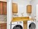 Well-organized laundry room with modern washer and dryer and wooden countertops at 11423 Brighton Knoll Loop, Riverview, FL 33579