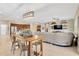 Open-concept living space with a kitchen island, dining area, and comfortable seating at 11423 Brighton Knoll Loop, Riverview, FL 33579