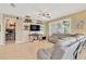 Inviting living room with a large sectional, a wall-mounted TV, and bright natural light at 11423 Brighton Knoll Loop, Riverview, FL 33579
