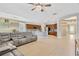 Expansive living room with a modern sectional sofa, tile floors, and an open floor plan, perfect for entertaining at 11423 Brighton Knoll Loop, Riverview, FL 33579