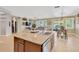 Open-concept living space with an island and tile flooring leading to the living room at 11423 Brighton Knoll Loop, Riverview, FL 33579