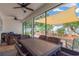 Covered patio featuring a large dining table with wicker chairs, ceiling fans, and views of the serene backyard at 11423 Brighton Knoll Loop, Riverview, FL 33579