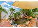 Backyard pond featuring lush plants and a small waterfall at 11423 Brighton Knoll Loop, Riverview, FL 33579