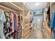 Organized walk-in closet with custom shelving, drawers, and ample storage space for clothes, shoes, and accessories at 11423 Brighton Knoll Loop, Riverview, FL 33579