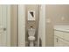 Bright bathroom with a toilet, shower with a white curtain and light neutral wall color at 11546 Flourish Dr, Land O Lakes, FL 34637
