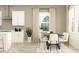 Light and airy dining area with a table set for six, modern chairs, and natural light at 11546 Flourish Dr, Land O Lakes, FL 34637