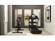 Home gym featuring a Peloton bike, a treadmill, and large mirrors at 11546 Flourish Dr, Land O Lakes, FL 34637