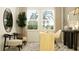 Home office space with a desk, chair, and a view of palm trees at 11546 Flourish Dr, Land O Lakes, FL 34637