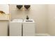 Well-organized laundry room with modern washer and dryer units and storage at 11546 Flourish Dr, Land O Lakes, FL 34637