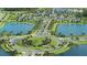 Aerial view featuring a roundabout entrance, lakes, and community amenities at 11730 Myakka Blue Dr, Venice, FL 34293