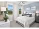 A stylish bedroom featuring a soft color palette and abundant natural light from large windows at 11730 Myakka Blue Dr, Venice, FL 34293
