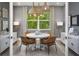 Cozy dining room featuring modern lighting, a round table, and built-in cabinets at 11730 Myakka Blue Dr, Venice, FL 34293