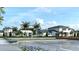 Community buildings featuring palm trees, colorful flowers, and ample parking at 11730 Myakka Blue Dr, Venice, FL 34293