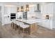 Bright kitchen with an island and breakfast bar, sleek white cabinets, and stainless steel appliances at 11730 Myakka Blue Dr, Venice, FL 34293