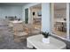 A cozy outdoor patio with modern furniture, a built-in grill, and seamless indoor-outdoor living at 11730 Myakka Blue Dr, Venice, FL 34293