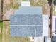 Aerial view of a house's roof showing the new shingles and the surrounding fences and small yard at 1213 W Camellia Dr, Brandon, FL 33510