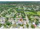 Aerial view of neighborhood with arrow identifying home's location amongst mature trees and quiet streets at 1213 W Camellia Dr, Brandon, FL 33510