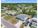 A sunny aerial view of a charming single-Gathering home nestled in a suburban neighborhood with mature trees at 1213 W Camellia Dr, Brandon, FL 33510