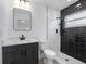 Modern bathroom featuring a sleek vanity, black fixtures, and a stylish shower with black and white tiling at 1213 W Camellia Dr, Brandon, FL 33510