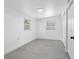 Bright bedroom with light wood-look floors and plenty of natural light from two windows at 1213 W Camellia Dr, Brandon, FL 33510