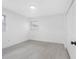 Bright bedroom with two windows offering plenty of natural light and neutral walls and light wood look floors at 1213 W Camellia Dr, Brandon, FL 33510