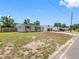 Wide angle of a single-story home with updated shutters, garage, and car port at 1213 W Camellia Dr, Brandon, FL 33510