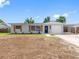 Charming single-story home featuring a carport, front lawn, and modern exterior paint at 1213 W Camellia Dr, Brandon, FL 33510