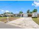 Single-story home featuring a garage, car port, driveway, and updated shutters at 1213 W Camellia Dr, Brandon, FL 33510