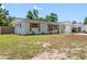 Side view of home featuring updated shutters, landscaping, and updated paint at 1213 W Camellia Dr, Brandon, FL 33510