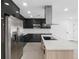 Modern kitchen featuring sleek black cabinetry, stainless steel appliances, quartz countertops, and a central island at 1213 W Camellia Dr, Brandon, FL 33510