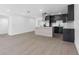 Open concept area features a sleek kitchen with stainless steel appliances and an island at 1213 W Camellia Dr, Brandon, FL 33510