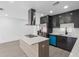 Modern kitchen featuring sleek black cabinetry, stainless steel appliances, quartz countertops, and a central island at 1213 W Camellia Dr, Brandon, FL 33510