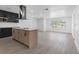 Modern kitchen featuring sleek black cabinetry, stainless steel appliances, quartz countertops, and a central island at 1213 W Camellia Dr, Brandon, FL 33510