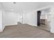 Open living room showcasing recessed lighting, gray wood-look floors, and an open-concept design to the kitchen at 1213 W Camellia Dr, Brandon, FL 33510
