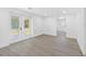 Bright living room with light wood-look floors and access to the backyard at 1213 W Camellia Dr, Brandon, FL 33510
