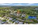 Picturesque aerial view of a neighborhood with well-maintained homes, mature trees, and a peaceful pond at 12510 Loquat Way, Tampa, FL 33626