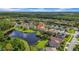 Aerial view showcasing the home's location within a quiet community, near the tranquil pond and lush green landscape at 12510 Loquat Way, Tampa, FL 33626