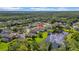 Beautiful aerial view showcasing the home's location near a tranquil pond, surrounded by lush greenery at 12510 Loquat Way, Tampa, FL 33626