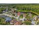 Aerial view showcasing the home's location within the peaceful community, near lush greenery and a tranquil pond at 12510 Loquat Way, Tampa, FL 33626