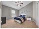 Bright bedroom with a ceiling fan, large window, and light grey walls at 12510 Loquat Way, Tampa, FL 33626