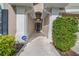 Covered walkway to the front door framed by manicured landscaping, and home security system at 12510 Loquat Way, Tampa, FL 33626