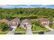 Beautifully landscaped home near a tranquil pond surrounded by lush greenery and other well-maintained houses at 12510 Loquat Way, Tampa, FL 33626