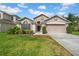 Charming single-Gathering home featuring a well-maintained lawn, neutral colors, and a two-car garage at 12510 Loquat Way, Tampa, FL 33626
