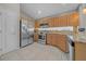 Well-lit kitchen with stainless steel appliances and ample wood cabinetry at 12510 Loquat Way, Tampa, FL 33626