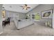 Bright living room with vaulted ceiling, large sectional sofa, and view of the backyard at 12510 Loquat Way, Tampa, FL 33626