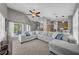 Spacious living room filled with natural light, carpet, and a seamless flow to the outdoors at 12510 Loquat Way, Tampa, FL 33626