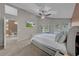 Bright main bedroom with a ceiling fan and access to the outdoor pool area at 12510 Loquat Way, Tampa, FL 33626