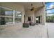 Covered patio space featuring stylish outdoor seating and a ceiling fan at 12510 Loquat Way, Tampa, FL 33626